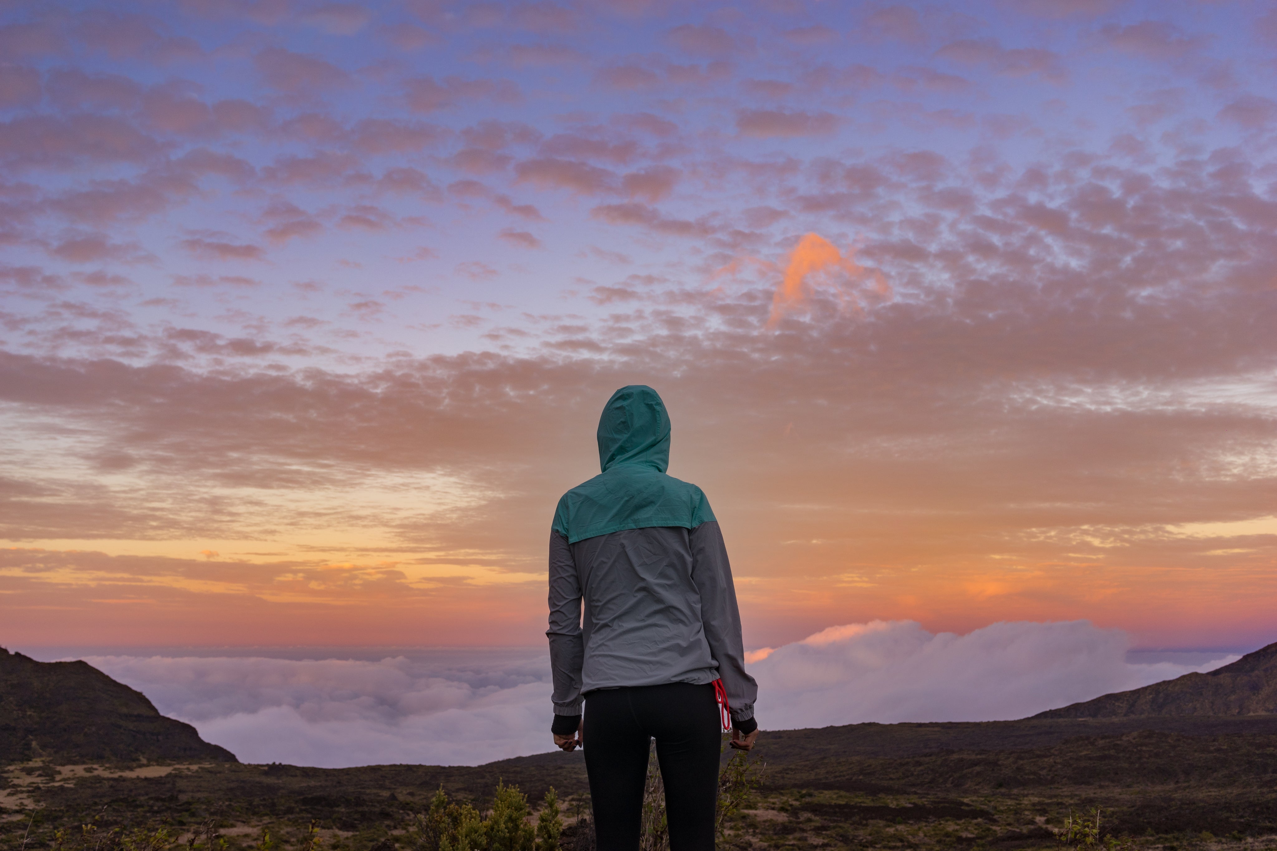 files/young-woman-standing-on-a-mountain-looking-over-the-clouds.jpg